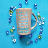 A Taupe hand painted mug with the words 