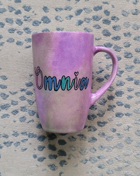 A Pastel Pink hand painted mug with the name "Omnia"