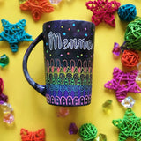 A Dark Sky hand painted mug with patterns on the bottom half horizontally inlayers of pink then purple then blue then green then yellow then orange, with colored dots scattered all over and the name 