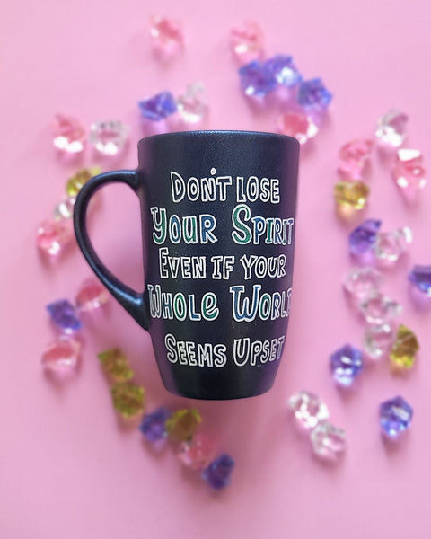 A Shimmery blue hand painted mug with the words "Don't lose your spirit, even if the whole world seems upset"