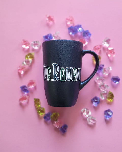 A Shimmery blue hand painted mug with the name "Dr. Rawan"