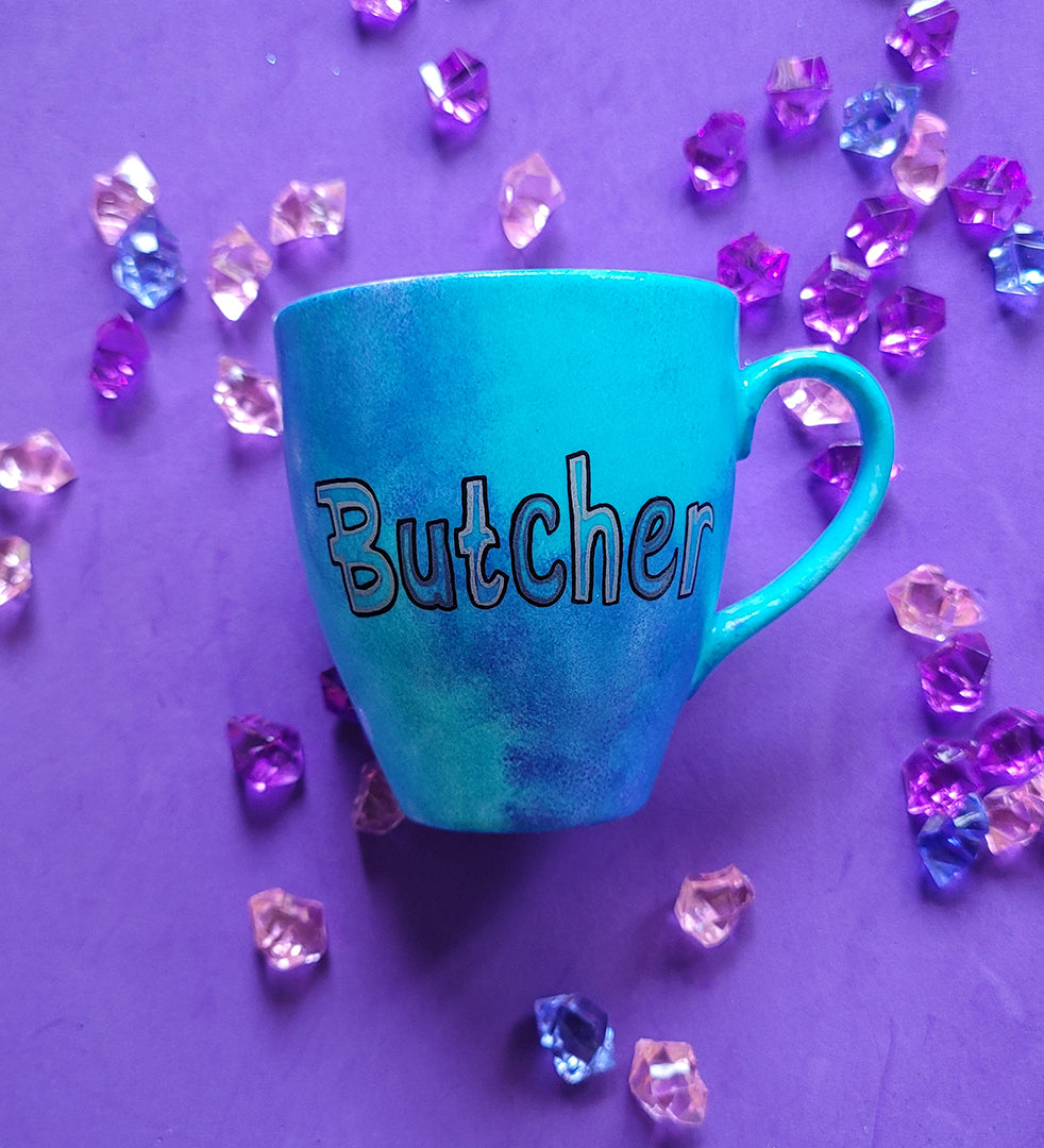 A Blue hand painted mug with the name "Butcher"r"