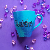 A Blue hand painted mug with the name 