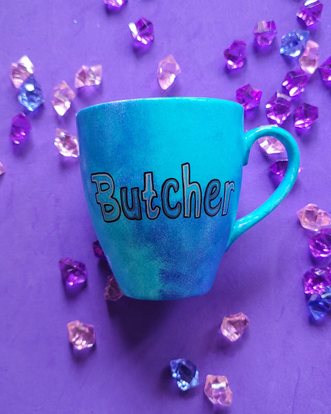 A Blue hand painted mug with the name "Butcher"r"