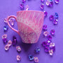 A Pink galaxy Hand painted mug with a 1/4 mandala drawn starting at the corner