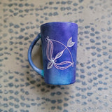 a hand-painted dark blue sky mug with a Sagittarius sign