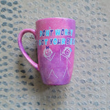 A hand painted pink galaxy mug with the words 