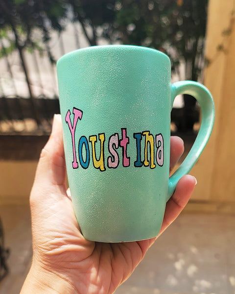 a min green hand painted mug with the name "youstina"