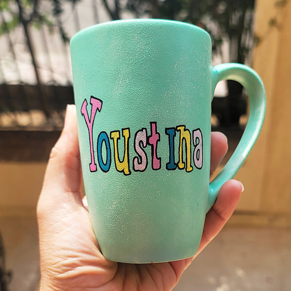 a min green hand painted mug with the name "youstina"