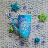 A Blue Galaxy Hand Painted mug with a mandala painted in white