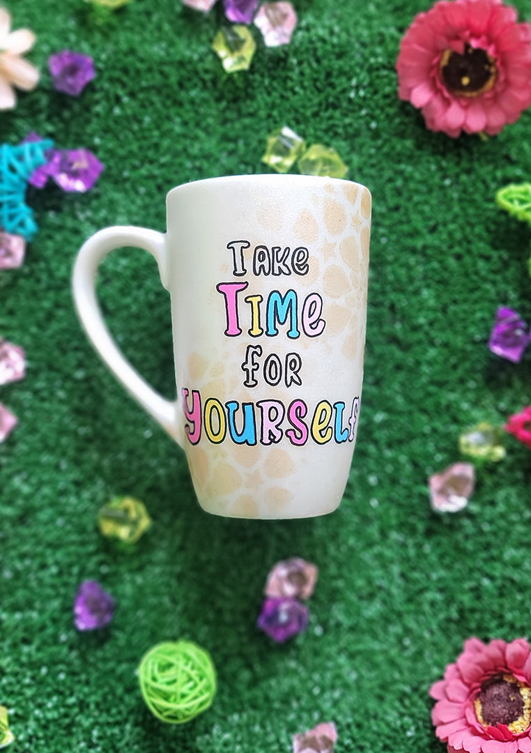 A Pearl white hand painted mug with gold geomteric patterns in the background and the words "Take time for Yourself"