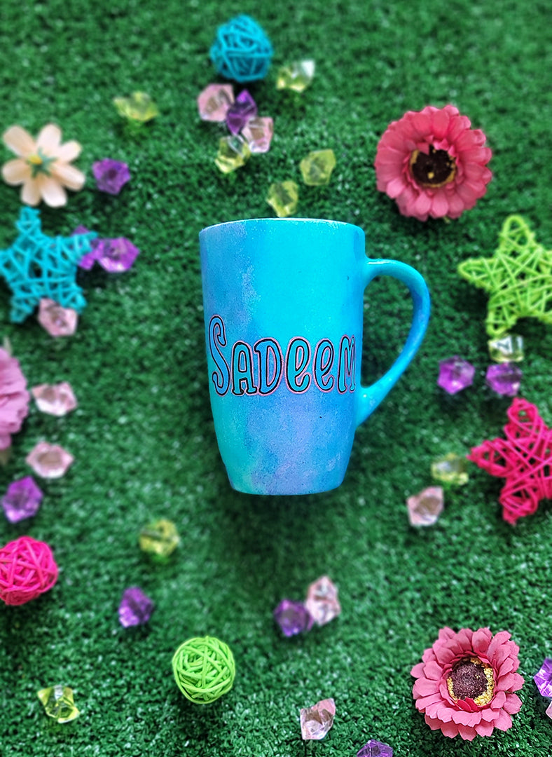 A Blue Hand painted mug with the name "sadeem "