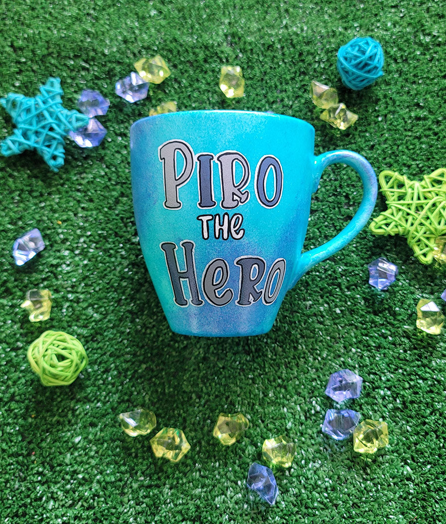 A Blue hand painted mug with the words "Piro he Hero"