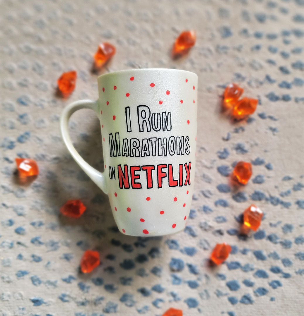 A Pearl White hand painted mug with the words "I Run Marathons" with red dots scattered all over