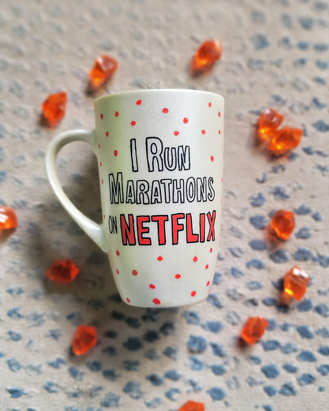 A Pearl White hand painted mug with the words "I Run Marathons" with red dots scattered all over