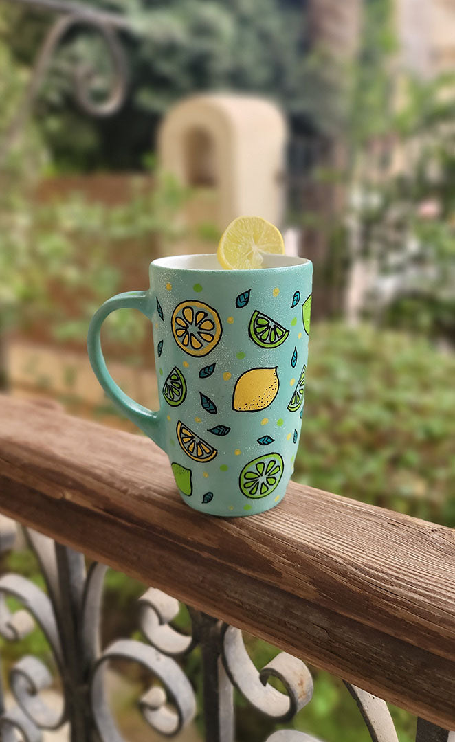 A Mint Green mug with lemons scattered all over