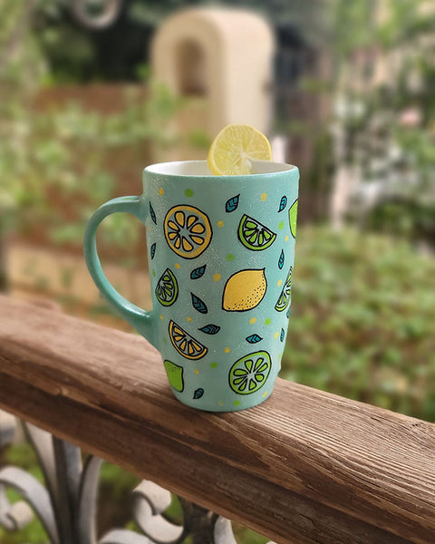 A Mint Green mug with lemons scattered all over