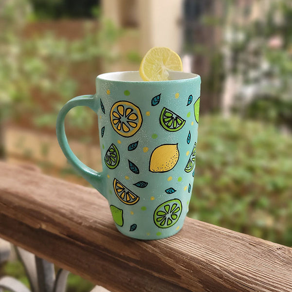 A Mint Green mug with lemons scattered all over