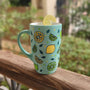 A Mint Green mug with lemons scattered all over