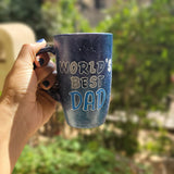 A black galaxy hand painted mug with the sentence 