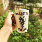 A pearl white hand-painted mug with the words 