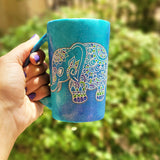 A Blue Galaxy hand painted mug with an elephant zentangle design on it in white