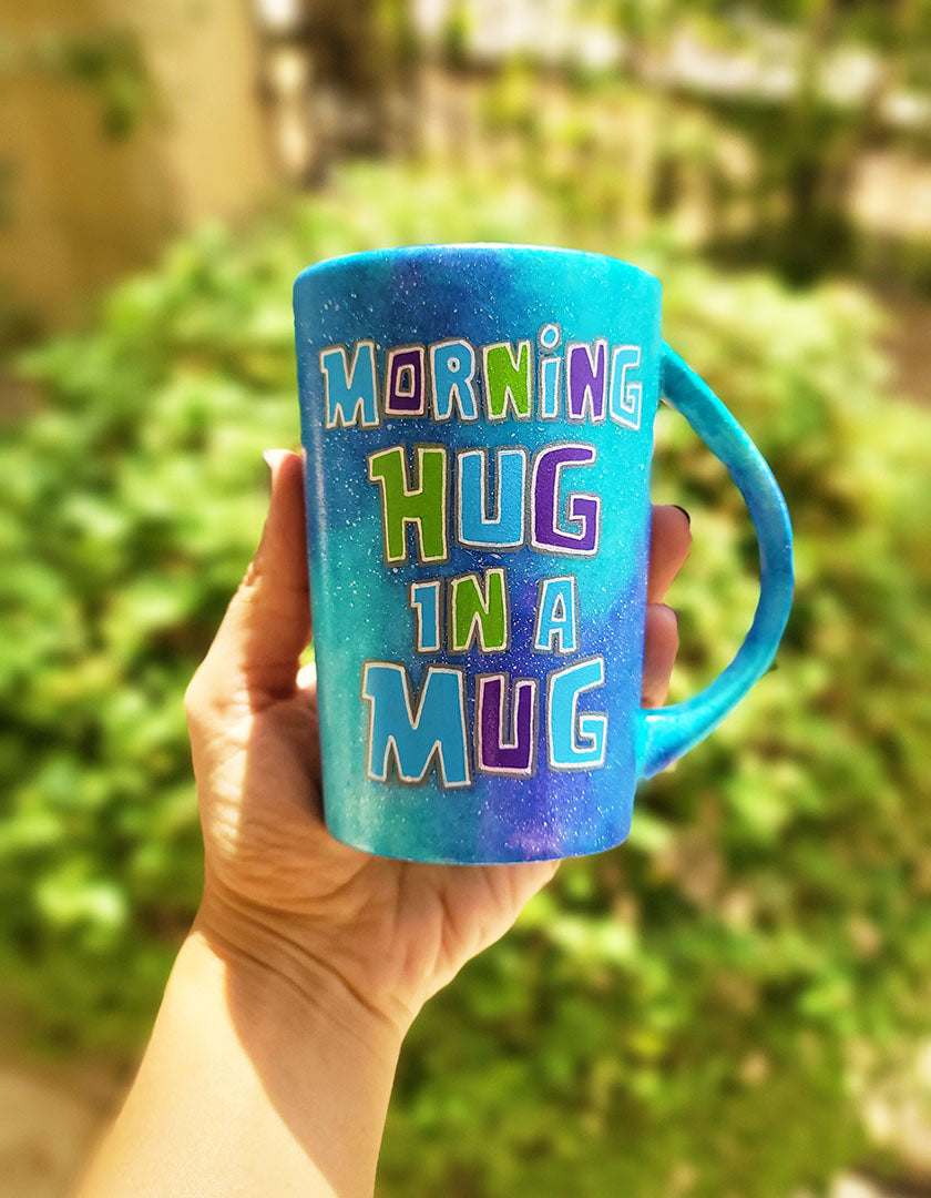 A Pink Galaxy hand painted mug with the sentence "Morning Hug in a Mug "