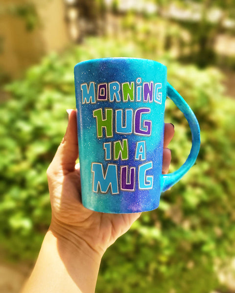 A Pink Galaxy hand painted mug with the sentence "Morning Hug in a Mug "