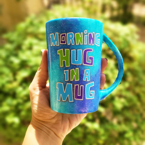 A Pink Galaxy hand painted mug with the sentence "Morning Hug in a Mug "