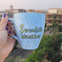 A baby blue hand painted mug with the sentence "Sweater Weather" in gold