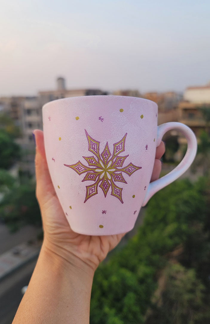 A Hand painted Baby Pink mug with a snowflake in gold