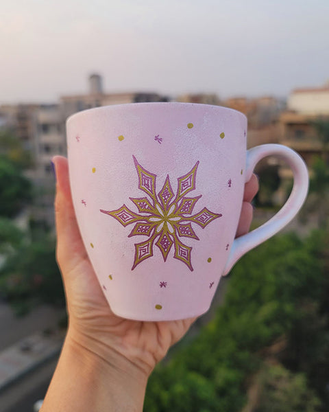 A Hand painted Baby Pink mug with a snowflake in gold