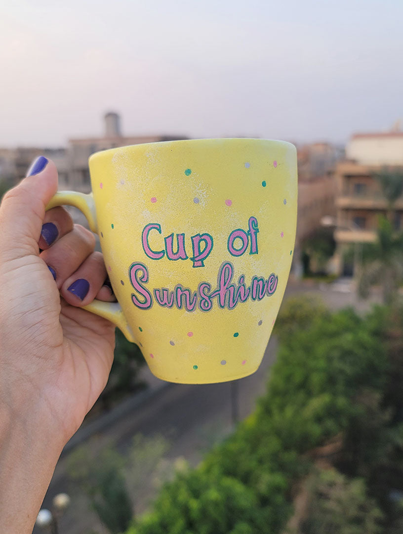 A Pastel yellow hand painted mug with the words "Cup of Sunshine"