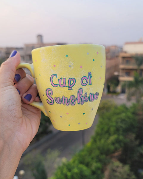 A Pastel yellow hand painted mug with the words "Cup of Sunshine"