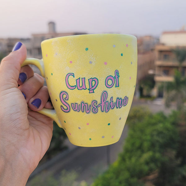 A Pastel yellow hand painted mug with the words "Cup of Sunshine"