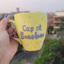 A Pastel yellow hand painted mug with the words "Cup of Sunshine"