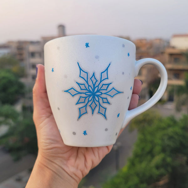 A Pearl White Hand painted mug with a snowflake inurquoise