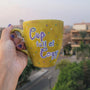 A Handpainted Greenish Bronze Mug with the sentence "Cup full of Cozy" in purple