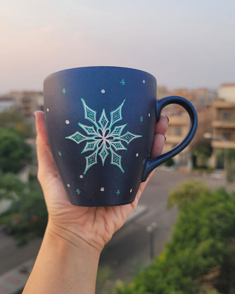 A Shimmery blue hand painted mug with the a Silver Snowflake