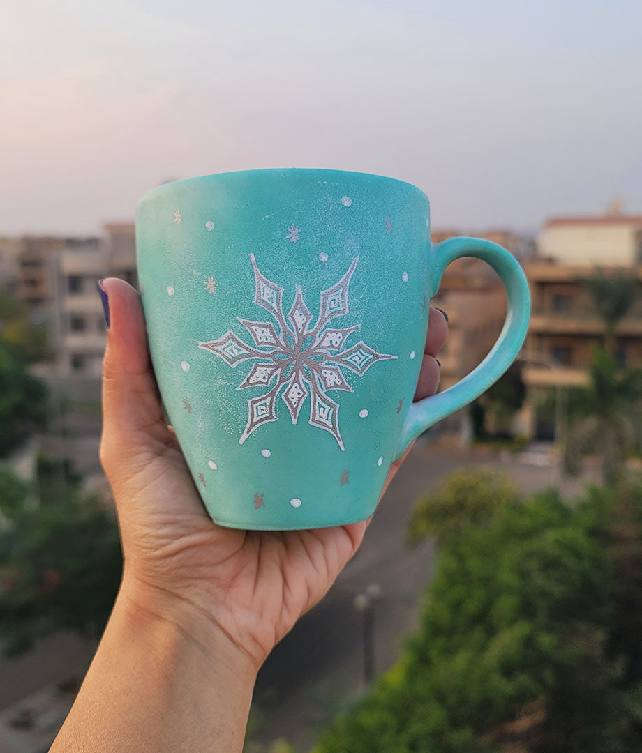 A Mint hand painted mug with A Snow flake