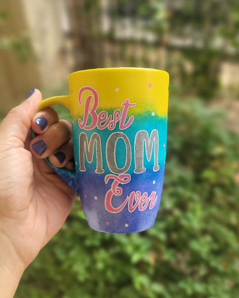 A Gradient colored hand painted mug with gradient colors of yellow turquoise and blue, with the words "Best Mom Ever"