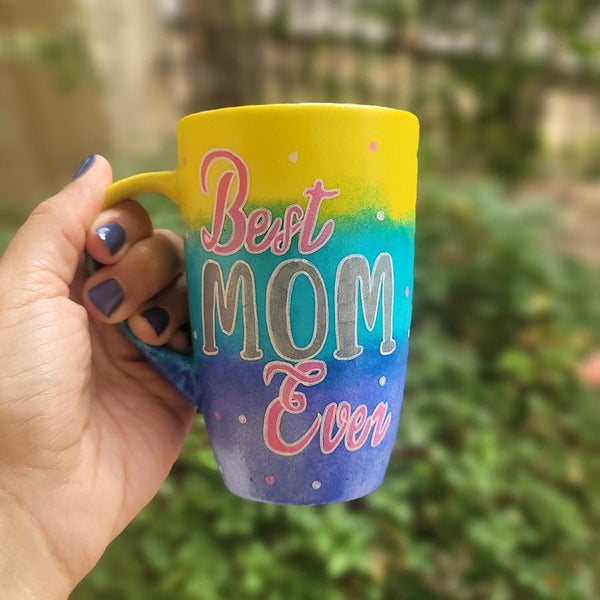 A Gradient colored hand painted mug with gradient colors of yellow turquoise and blue, with the words "Best Mom Ever"