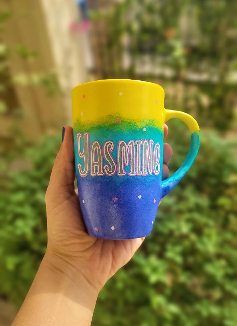 A Gradient colored hand painted mug with gradient colors of yellow turquoise and blue, with the name "Yasmine"