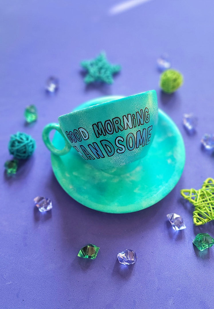 A Green Galaxy Hand painted cup and saucer with the sentence "good morning Handsome"