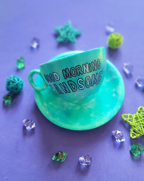 A Green Galaxy Hand painted cup and saucer with the sentence "good morning Handsome"