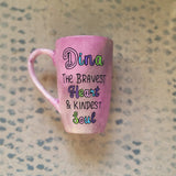 A Pastel Pink Hand painted mug with the name Dina wirtten on top and under it the sentence 