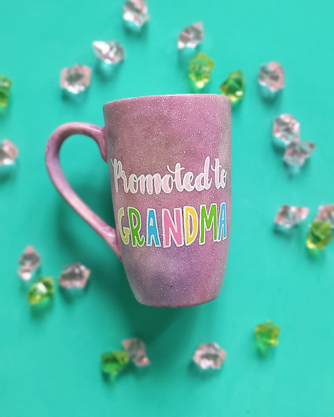 A Pink Pastel Galaxy hand painted mug with the words "Promoted to Grandma"