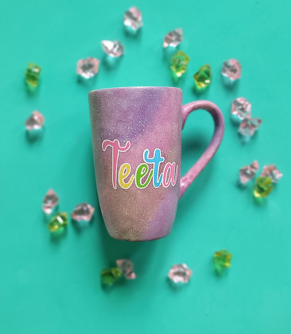 A Pink Pastel Galaxy hand painted mug with the word "Teeta"