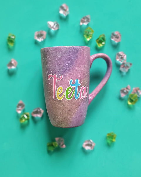 A Pink Pastel Galaxy hand painted mug with the word "Teeta"