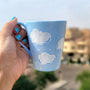 A Baby Blue Hand painted mug with white clouds drawn on it